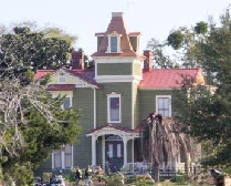 a group of people in front of a house