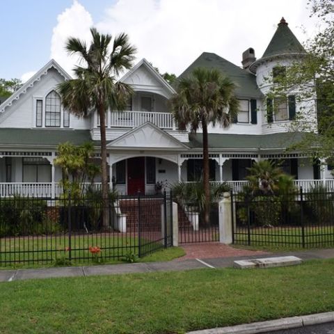 a tree in front of a house