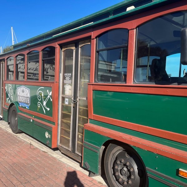 a passenger bus that is parked on the side of a train