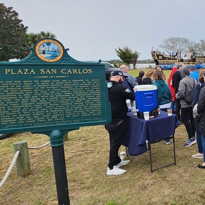 a group of people standing in front of a sign