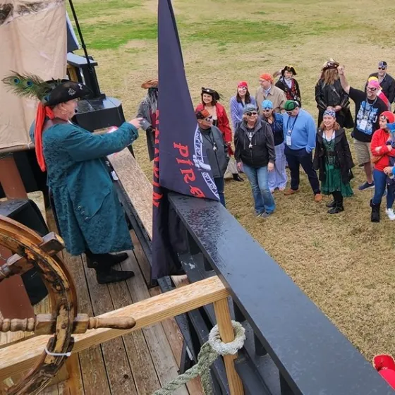 a group of people that are standing in the grass