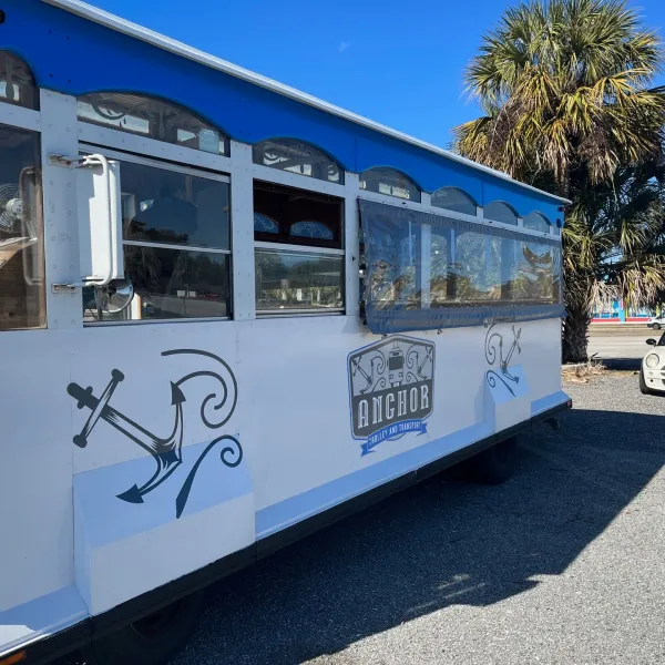 a passenger bus that is parked on the side of a road