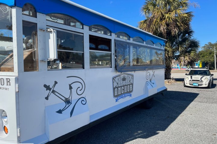 a passenger bus that is parked on the side of a road