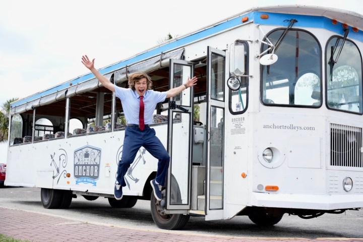 a person standing in front of a bus