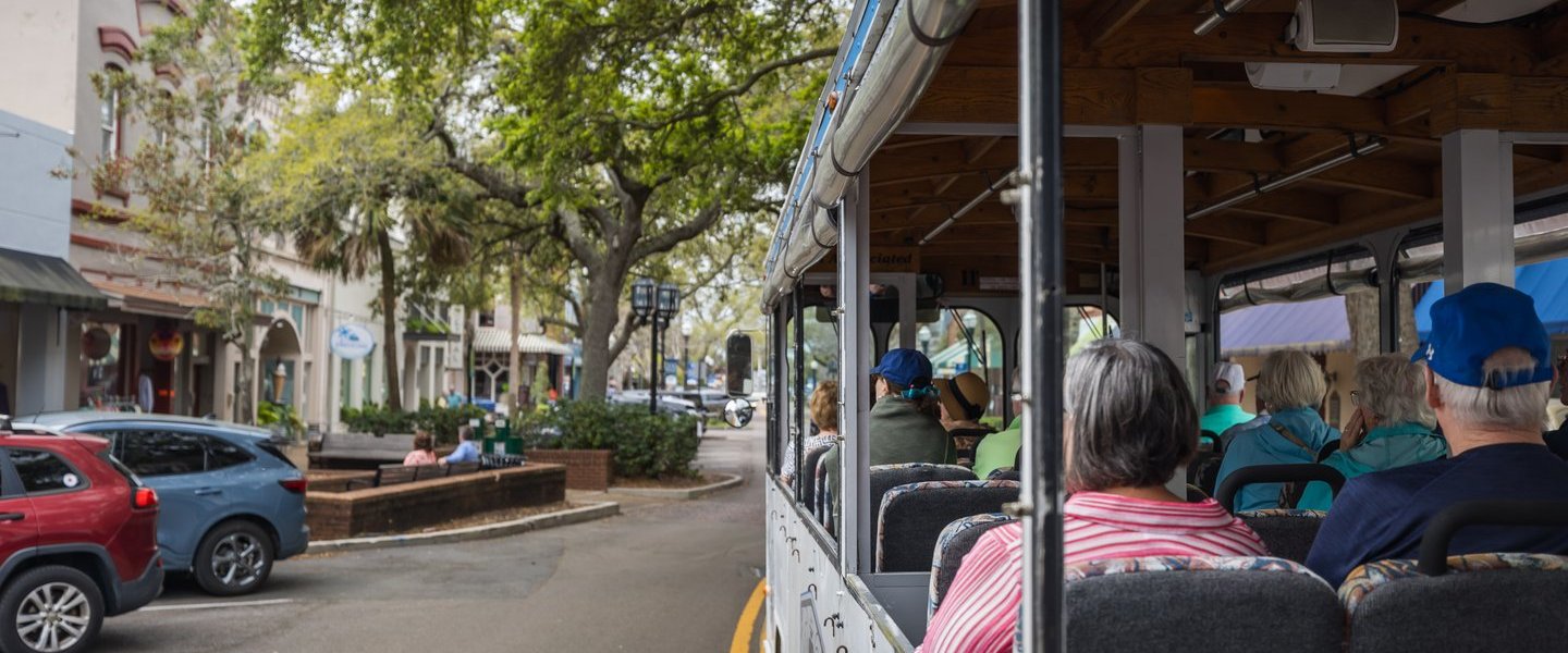 a group of people riding on the back of a car