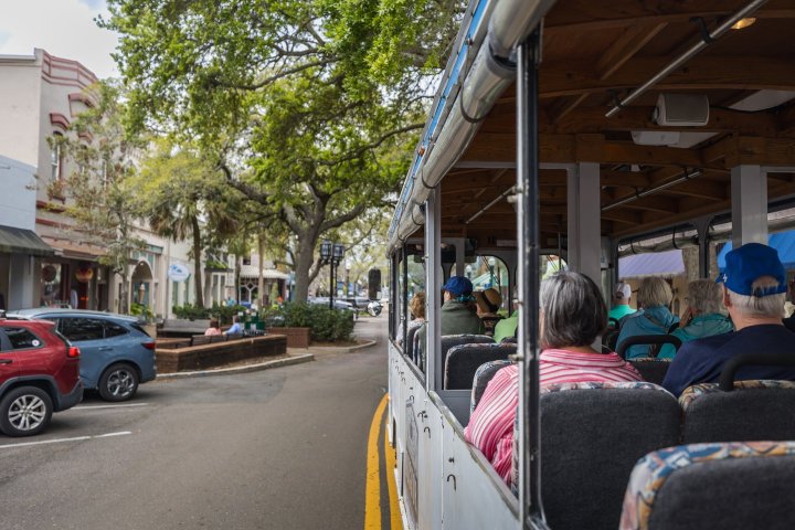 a group of people riding on the back of a car